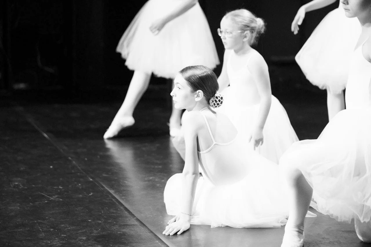 Young dancers in white romantic tutus on stage